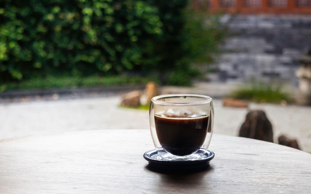 cup with espresso in garden