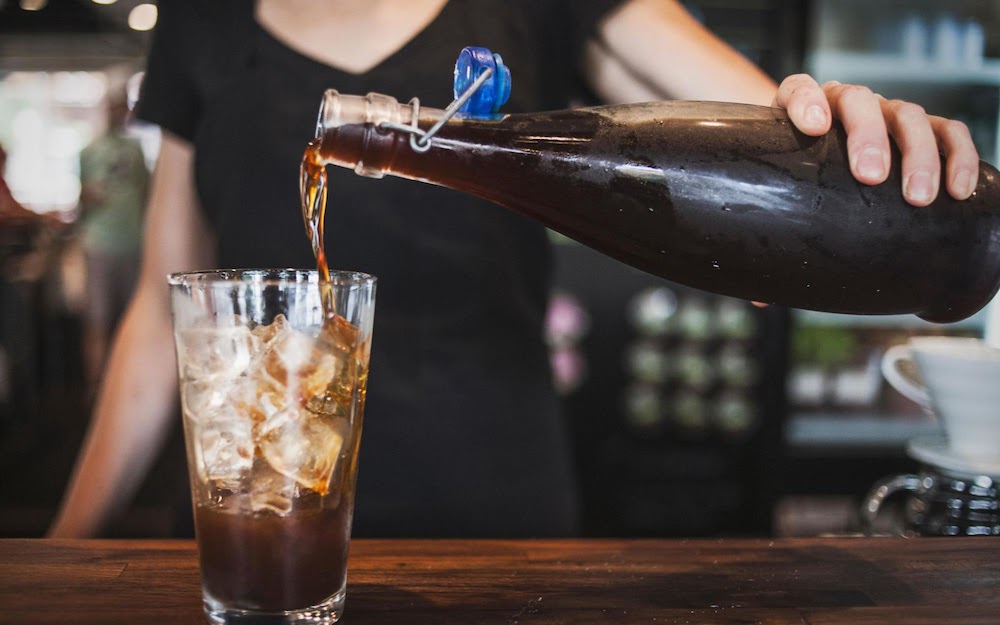 barista pouring cold press coffee