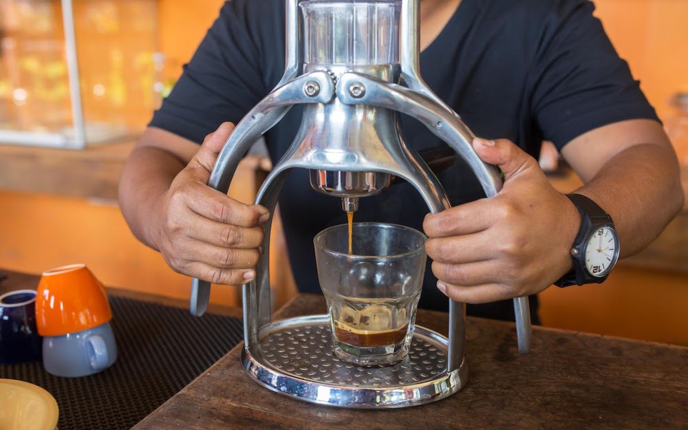 barista pressing out cold-press espresso