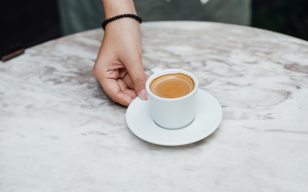 serving a shot of espresso on table