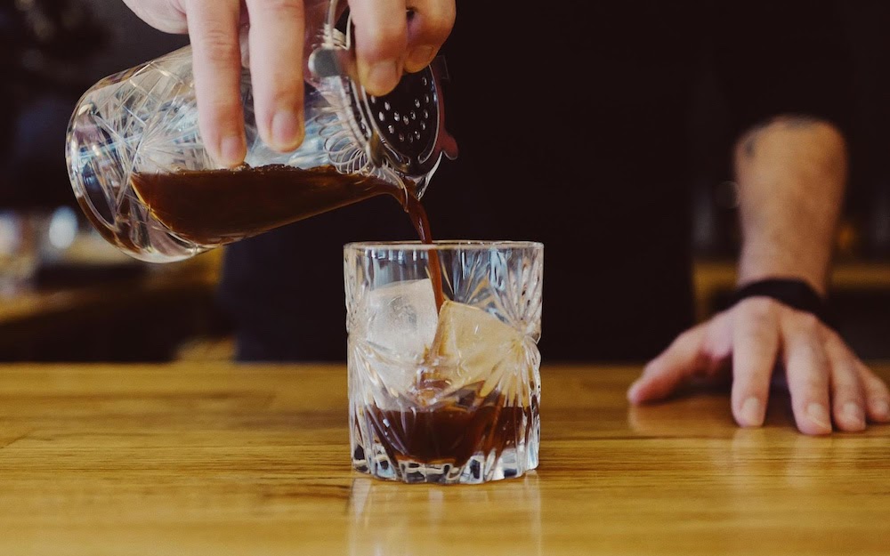barista pouring espresso tonic