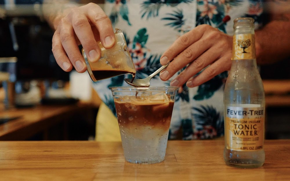 barista pouring espresso tonic