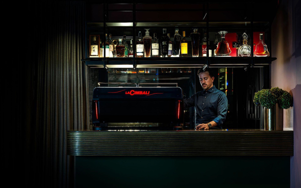 barista working behind lacimbali machine