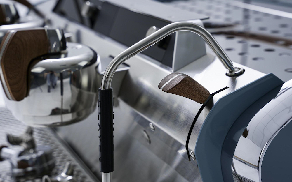 wood and stainless steel handle on a slayer coffee machine