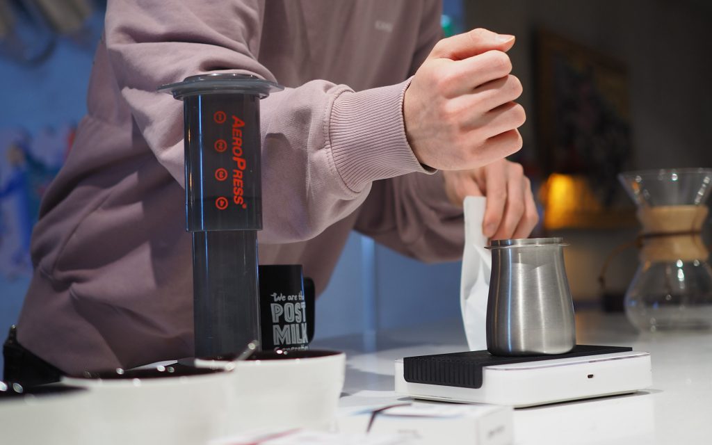 Tuomas Merikanto measures coffee beans using a scale