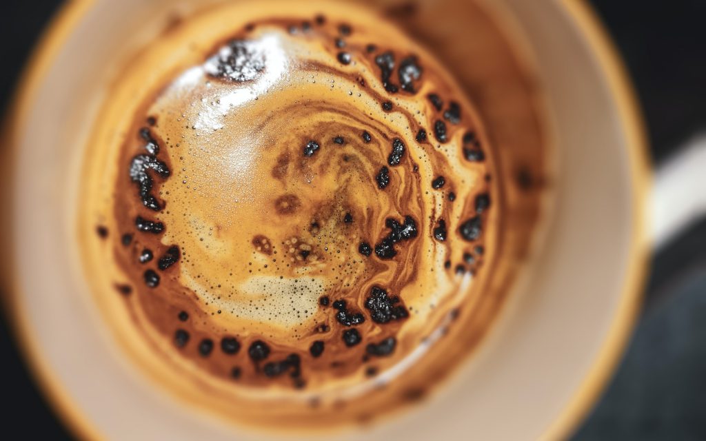 Instant coffee granules dissolving in a mug.