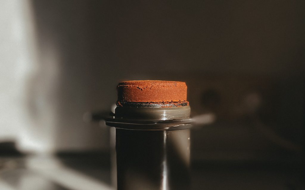 A puck of spent coffee grounds on an AeroPress.