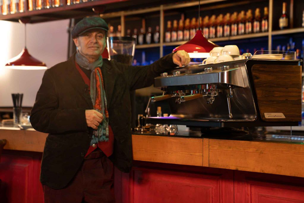 Travel and food writer Ayhan Sicimoğlu stands next to a Levee espresso machine