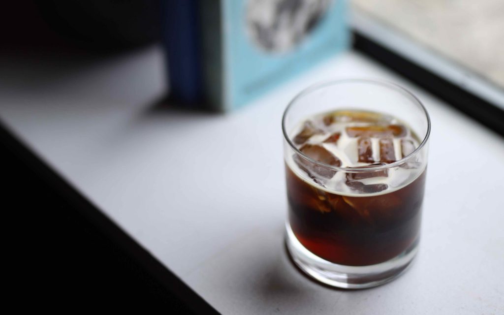 A glass of cold brew coffee with ice cubes.