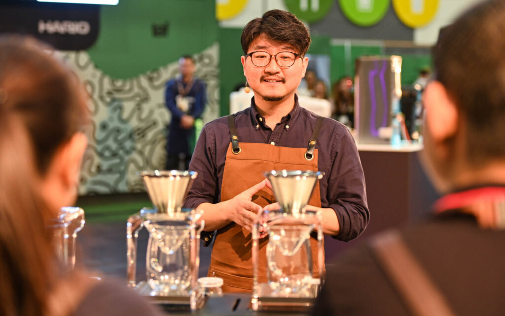 A coffee competitor explains his choice of competition coffee to judges.