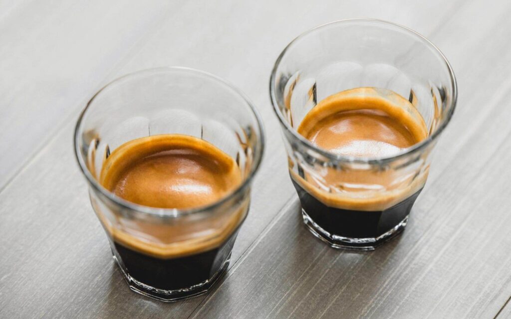 Two shots of espresso side by side.