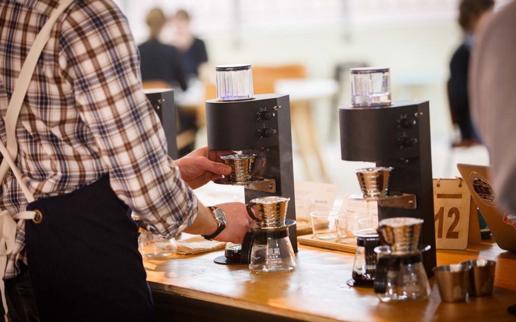 A barista brews a drink using the Marco SP9.