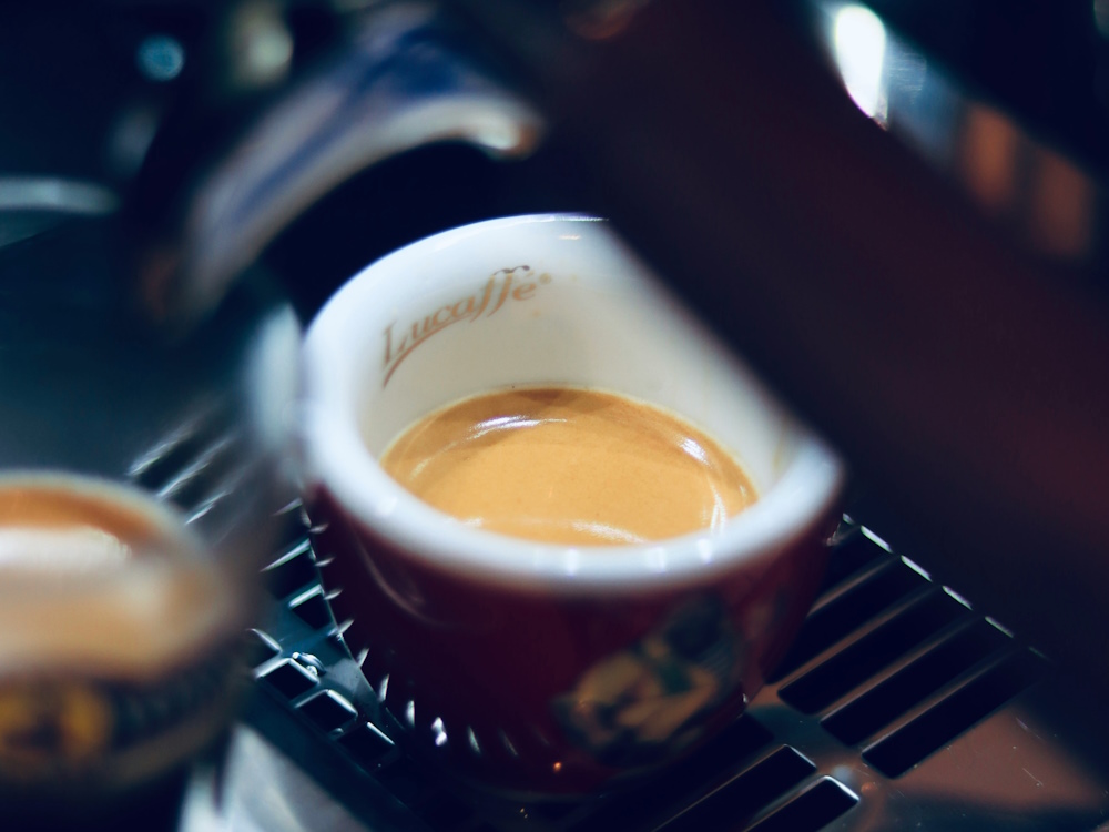 A double shot of espresso extracted into a cup.