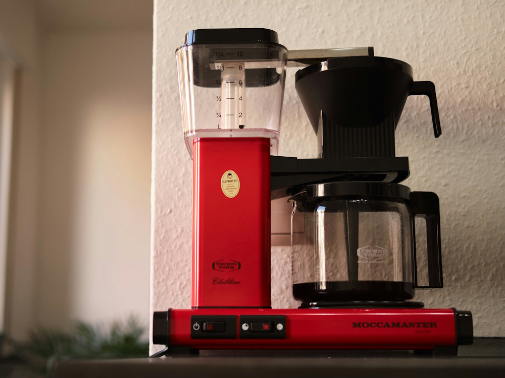 A red Moccamaster coffee machine.