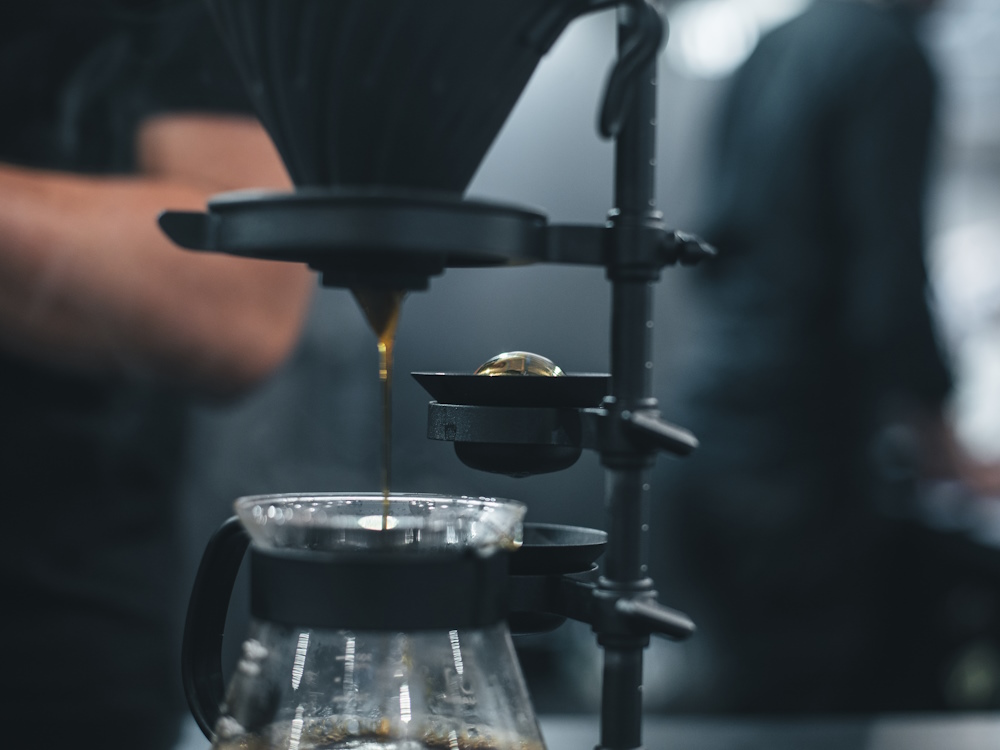 A barista uses the Paragon filter brewer.